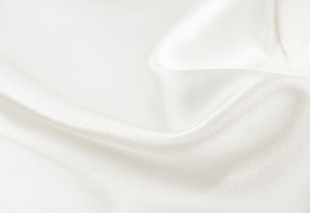 Obraz premium Background from white wrinkled fabric. White satin with folds and waves