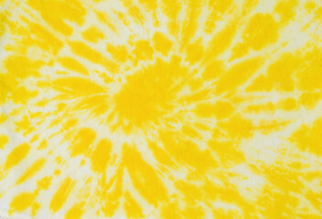 Beautiful white and yellow tie dye pattern on the fabric. Flat lay. - obrazy, fototapety, plakaty
