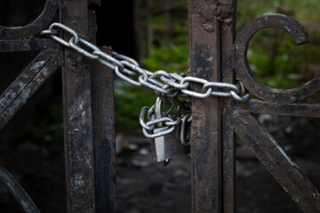 old iron gate closed with chain and padlock