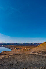 Icelandic landscape of colorful volcanic caldera Askja, Viti crater lake in the middle of volcanic desert in Highlands, with red, turquoise volcano soil and hiking trail, Iceland