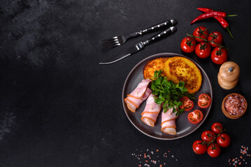 Slices of delicious raw or salted bacon with spices, salt, vegetables and herbs on a wooden cutting board