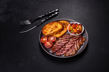 Slices of delicious grilled bacon with croutons fried in egg with spices, salt, vegetables and herbs