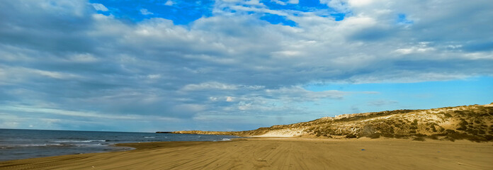 Panoramic view of beach and seaside under a cloudy sky during summertime, Tourism concept. Mostaganem, Algeria