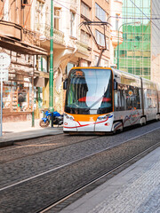 Typical tram on tracks in the streets of Prague city, Czech Republic. Public transport concept