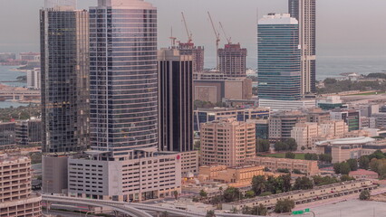 Fototapeta premium Office buildings in Dubai Internet City and Media City district aerial night to day timelapse