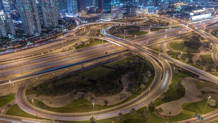 Fototapeta na wymiar Aerial view on Dubai Marina with big highway intersection night timelapse and skyscrapers around, UAE