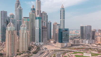Skyscrapers of Dubai Marina near intersection on Sheikh Zayed Road with highest residential buildings all day timelapse