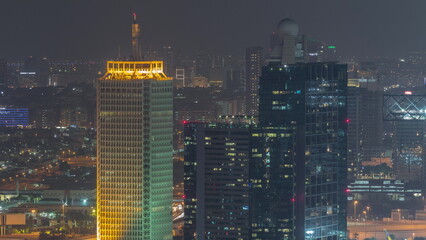 Aerial view of skyscrapers with World Trade center in Dubai night timelapse.