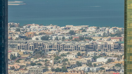 Fototapeta premium Aerial view of apartment houses and villas in Dubai city timelapse, United Arab Emirates