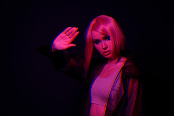Woman in futuristic costume. Augmented reality game, future technology, AI concept. VR. Neon red...