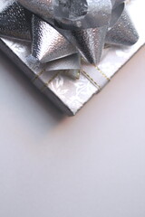 silver gift box and silver ribbon on white background