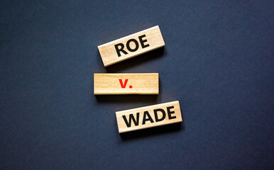 Abortion process Roe versus Wade symbol. Concept words Roe versus Wade on wooden blocks. Beautiful...