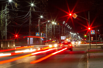 Fototapeta na wymiar Long exposure of cars headlights and traffic light at night city