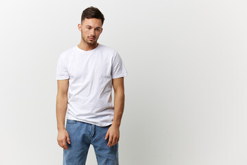 Fototapeta premium Tired frustrated tanned handsome man in basic t-shirt think about problems at work posing isolated on over white studio background. Copy space Banner Mockup. People emotions Lifestyle concept