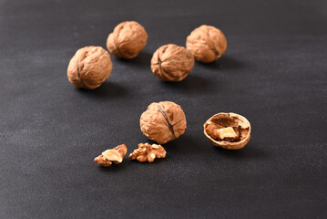 Walnut and walnut shell on dark background.