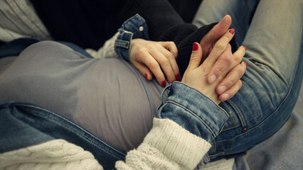 Two people relaxing beach. Multiethnic couple relaxing holding hands outdoors.