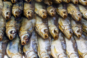 Snack for beer dried fish vobla lies in rows on the counter