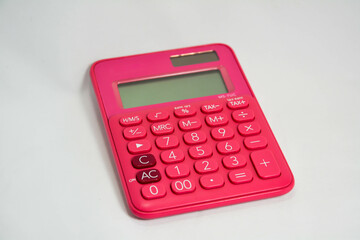 pink calculator with white background.