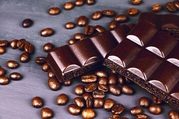 Dark porouse chocolate and coffee beans flat lay. Brown background