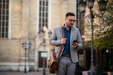 Business man walking down the city