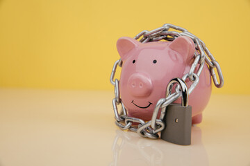 Piggy bank with chain and lock with copy space