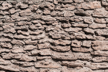 Photo of a fragment of a wall made from rough stone