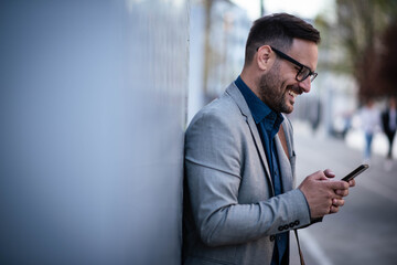 Young manager is texting message on cell phone