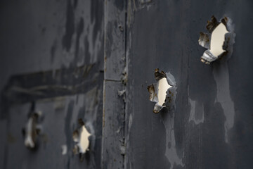 Bullet holes in metal door from iron plate - obrazy, fototapety, plakaty