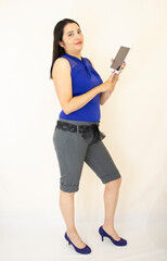 
beautiful, successful, elegant business woman in gray shorts and blue blouse, in purple heels, standing organizing her tasks on the tablet, on white backgroun