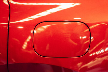 Detail of the fuel tank entry on a red car