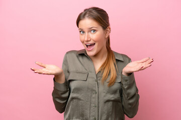 Young caucasian woman isolated on pink background with shocked facial expression