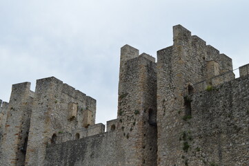 Fototapeta na wymiar Stone walls and towers of a medieval castle from the 15th century