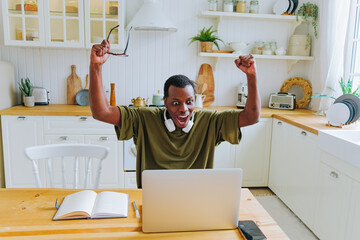 African American man with glasses and headphones gets surprised after winning lottery. Confused...