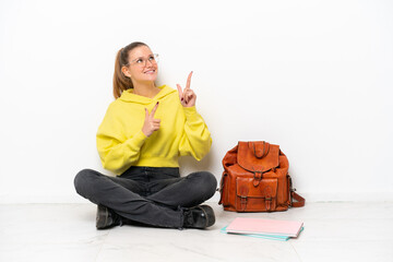 Young student caucasian woman sitting one the floor isolated on white background pointing with the index finger a great idea