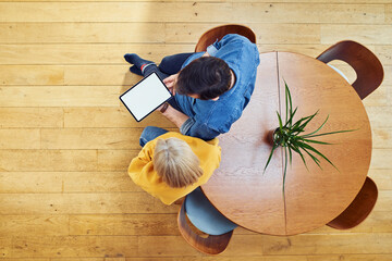 Top view of couple using tablet at home