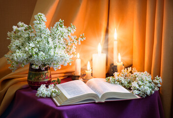 Still life from ancient book and lush boquet