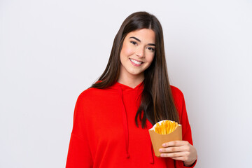 Young Brazilian woman catching french fries isolated on white background smiling a lot