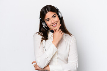 Telemarketer caucasian woman working with a headset isolated on white background smiling