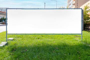 Wide advertising billboard mock-up in the city on a sunny summer day