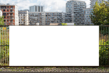 Obraz premium Advertising banner mock-up on the fence of construction site in the city