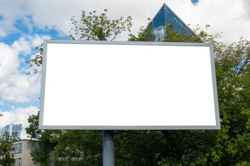 Blank white billboard for advertisement in front of modern office building with glass facade