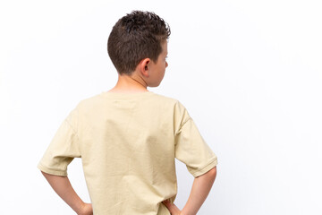 Little caucasian boy isolated on white background in back position and looking side