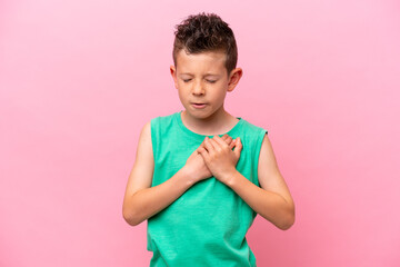 Little caucasian boy isolated on pink background having a pain in the heart © luismolinero
