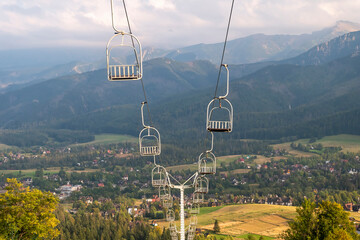 View of chairlift over the Zakopane and Koscielisko in Tatra Mountains, Poland. There are mountain...