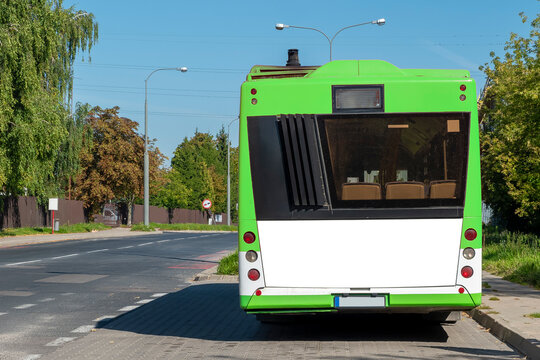Modern green and white bus with blank white space for advertisement