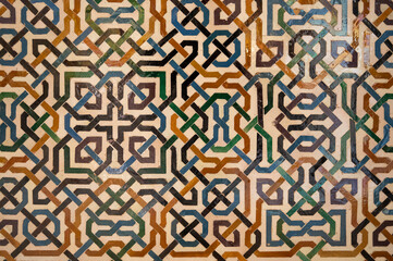Ornamental medieval ceramic tiles of walls in Nasrid Palaces in the Alhambra palace Granada, Andalusia, Spain - obrazy, fototapety, plakaty