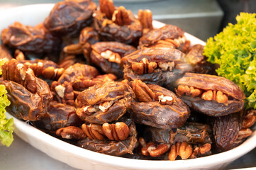 Turkish or arabic sweet dessert, ripe dried dadels with walnuts sweetened with syrup or honey.