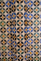 Ornamental medieval ceramic tiles of walls in Nasrid Palaces in the Alhambra palace Granada, Andalusia, Spain