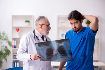 Fototapeta premium Two male doctors working in the clinic