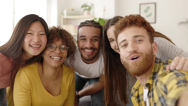 Hipster brazilian man taking selfie photo with his multiracial friends at home - Millennial young people having fun together - Multicultural friendship concept